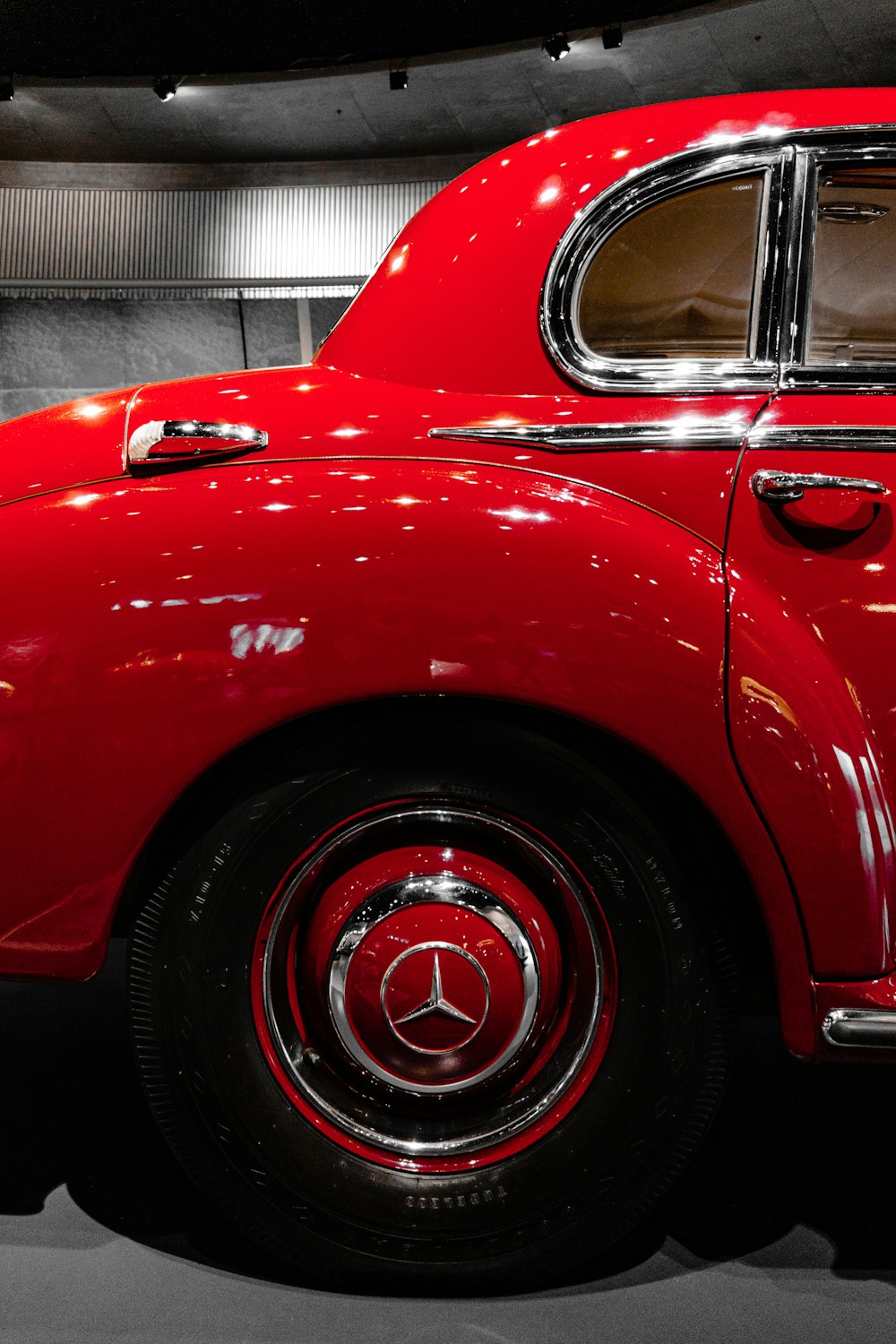 a red car is parked in a garage