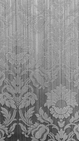 Elegant fabric featuring delicate flowers in soft pastel shades with visible texture