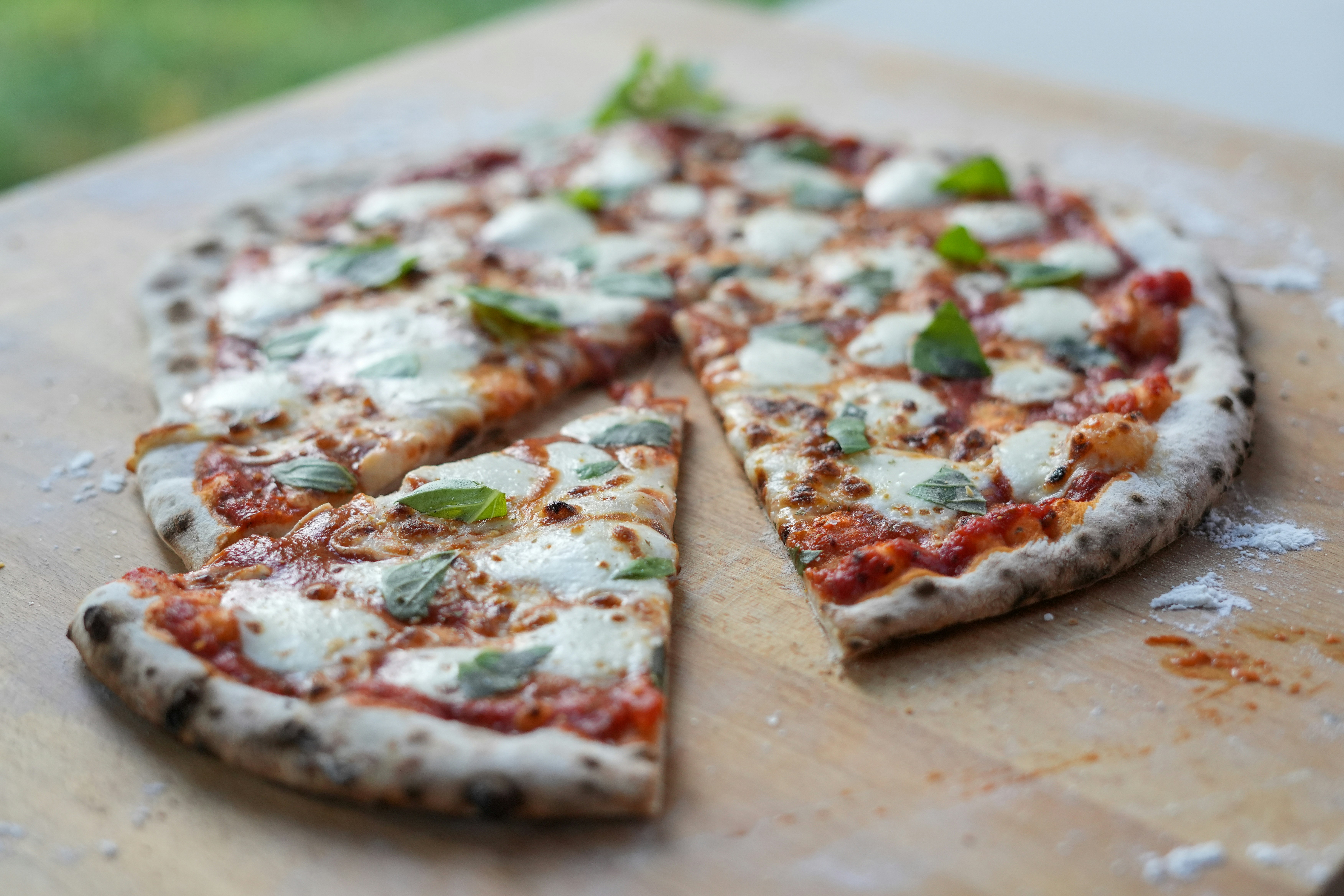 Classic margherita pizza with fresh mozzarella and basil on wood-fired crust