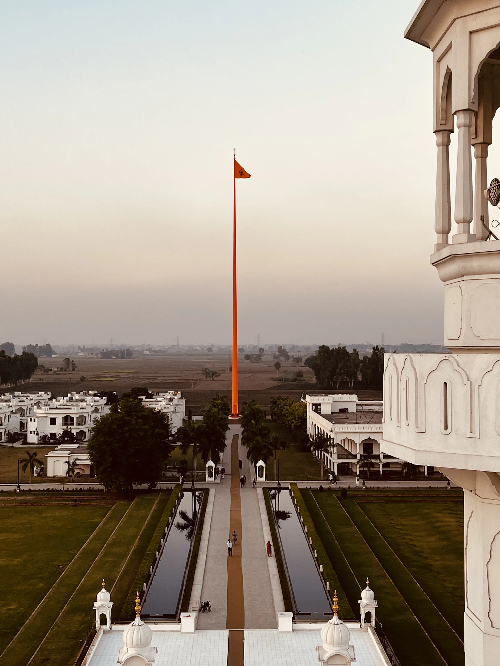 a large white building with a flag on top of it