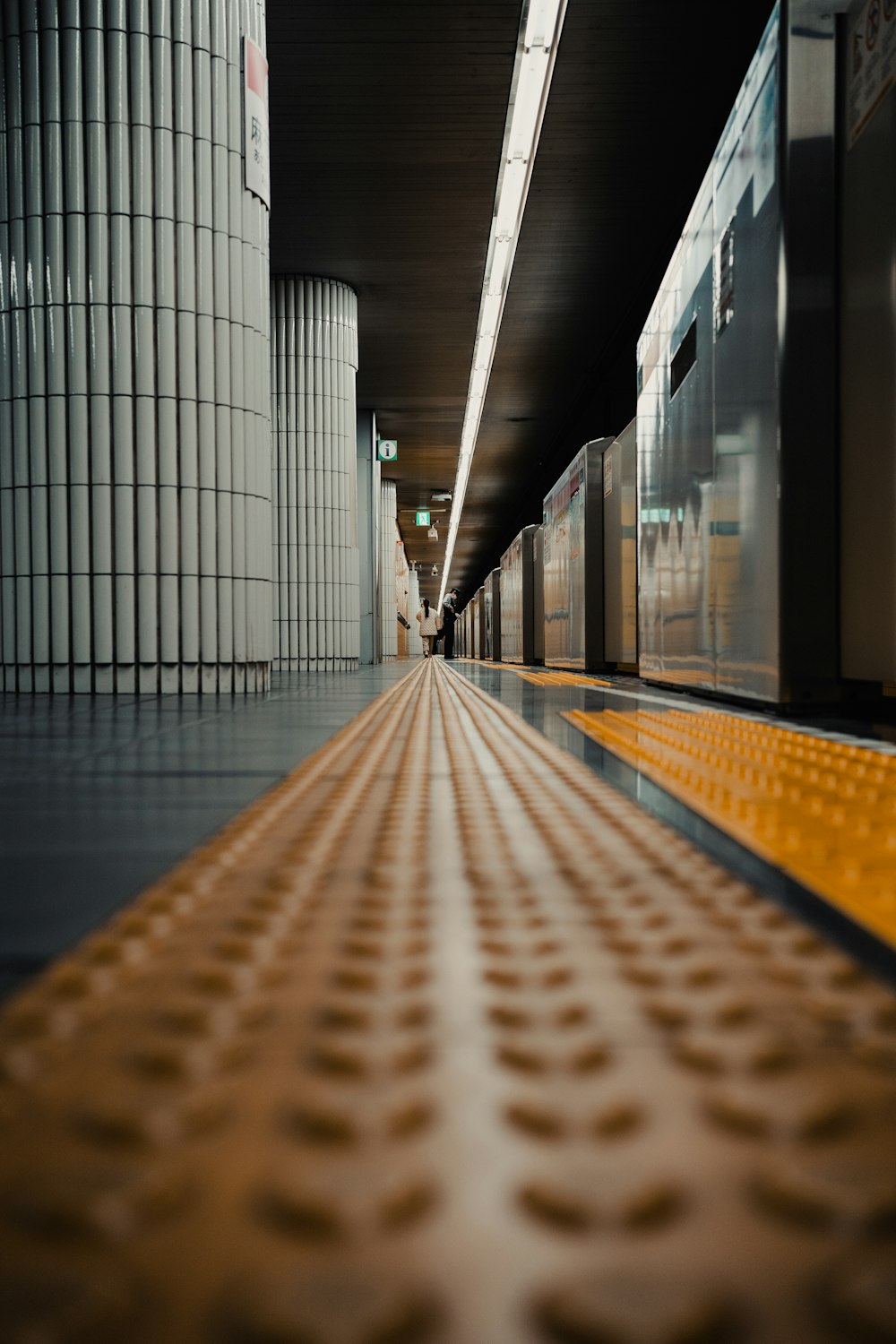 a train traveling through a train station next to tall buildings