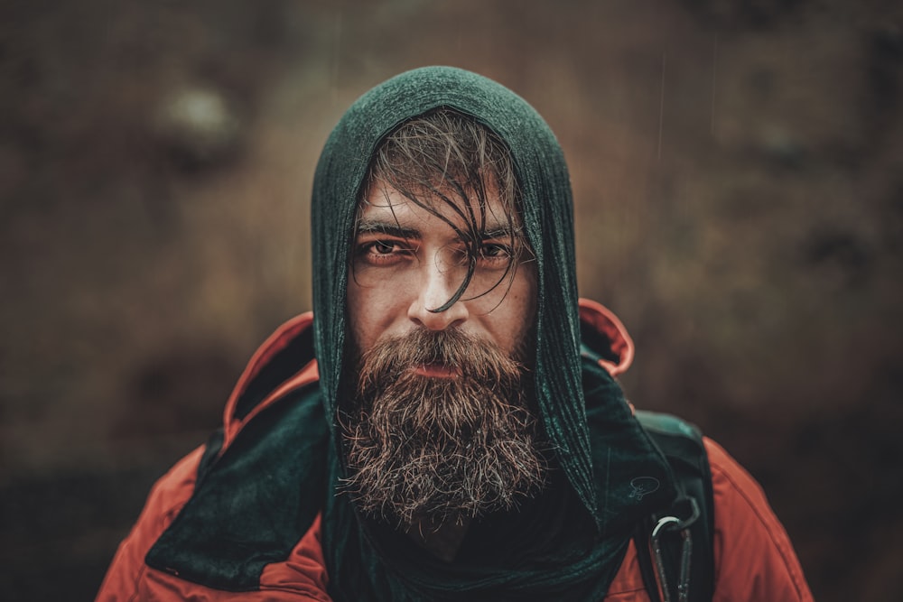 a man with a beard wearing a green hoodie