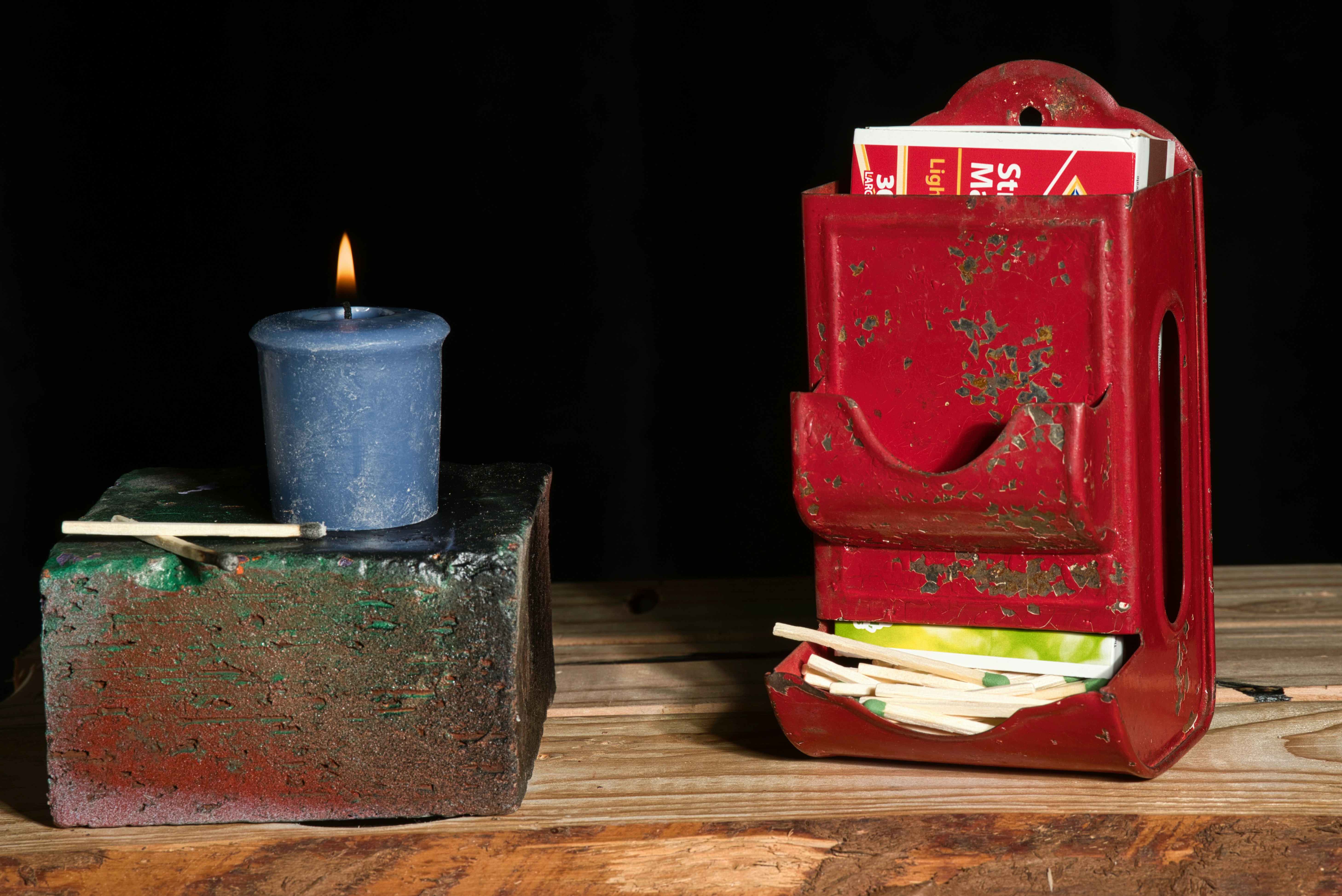a candle is lit next to a red box