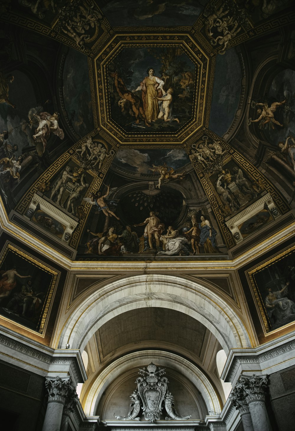 the ceiling of a building with paintings on it