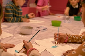 Kids participating in a creative art workshop with colorful supplies