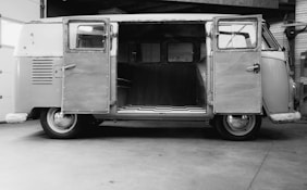a black and white photo of an old vw bus
