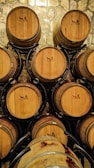 Artisan craftsmen refurbishing used barrels.