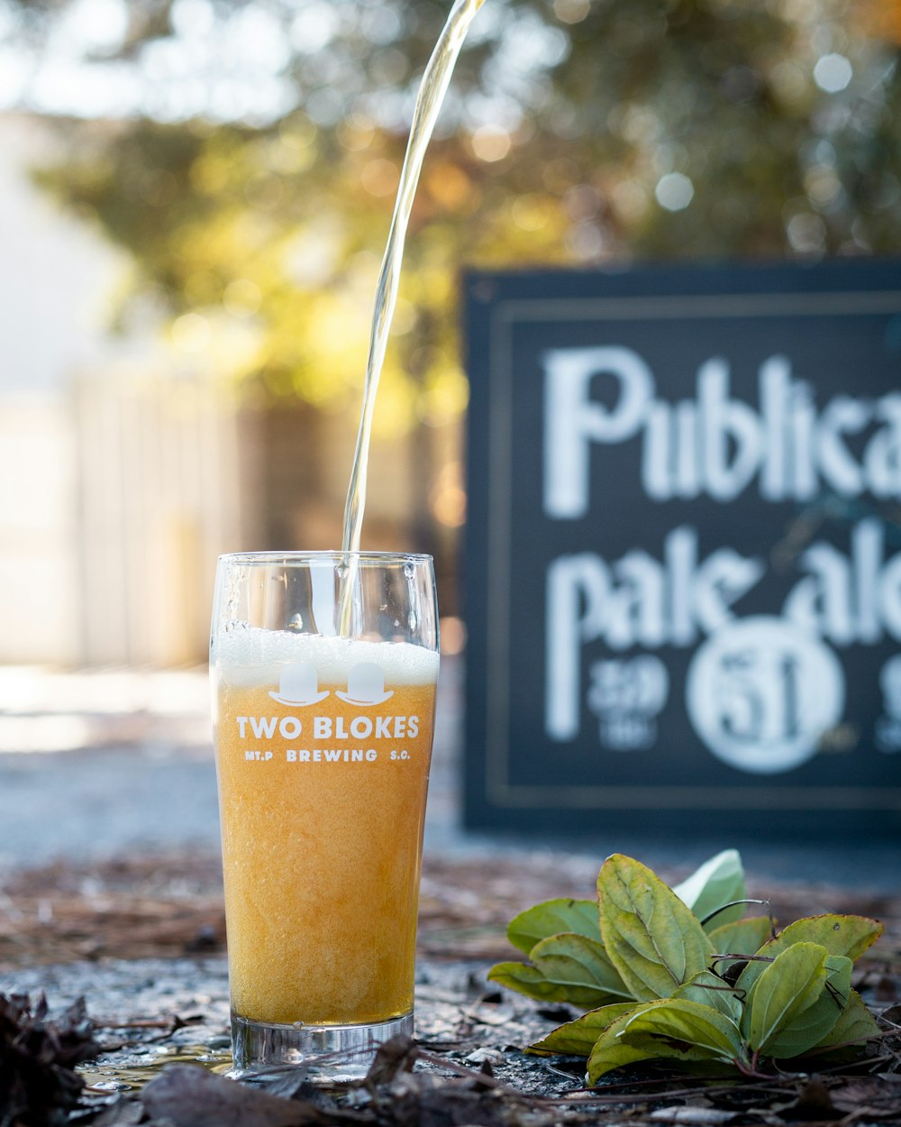 a glass of beer being poured into it