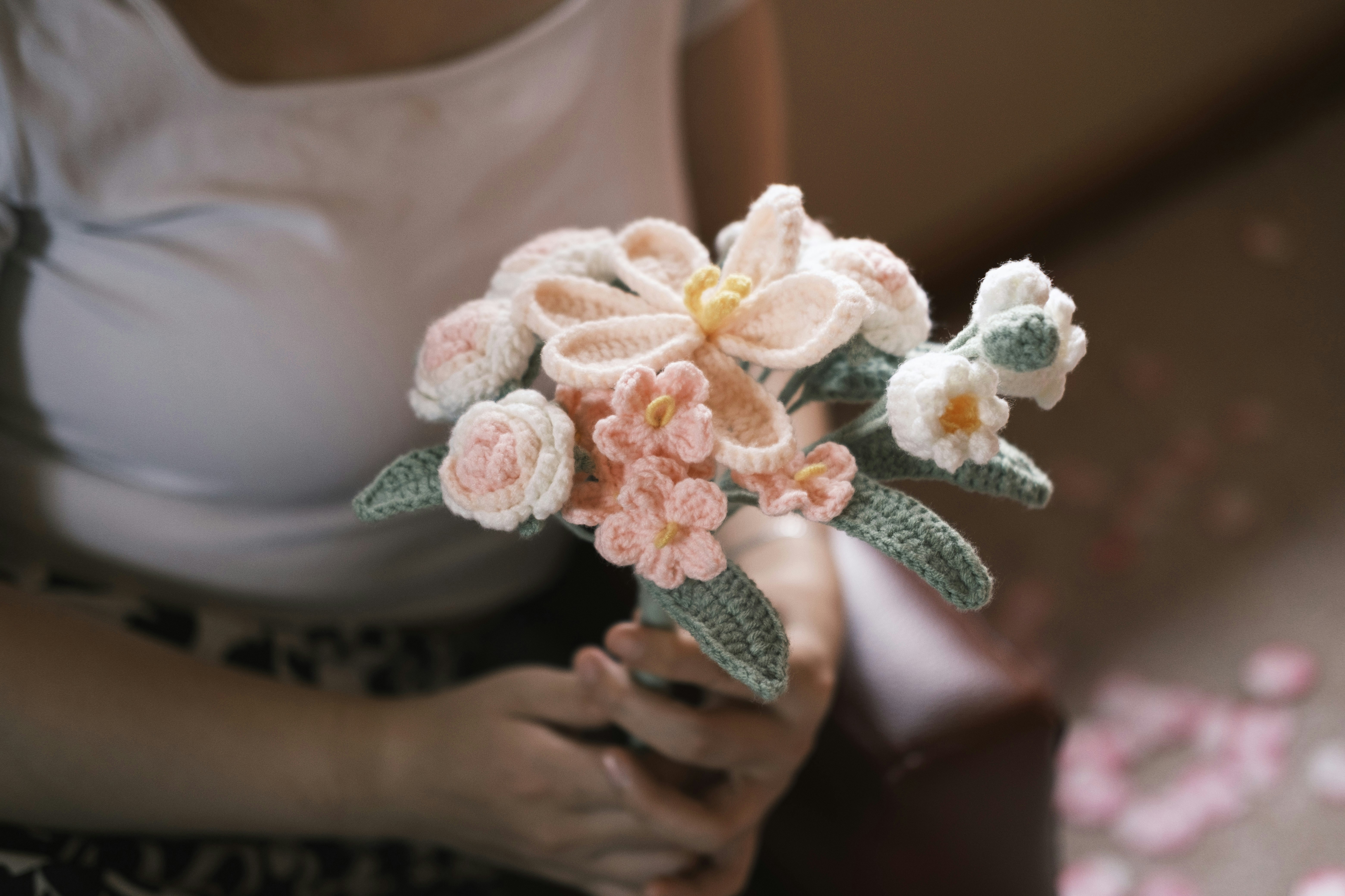 Handmade crochet flower bouquet in pastel pink and lavender colors on white background