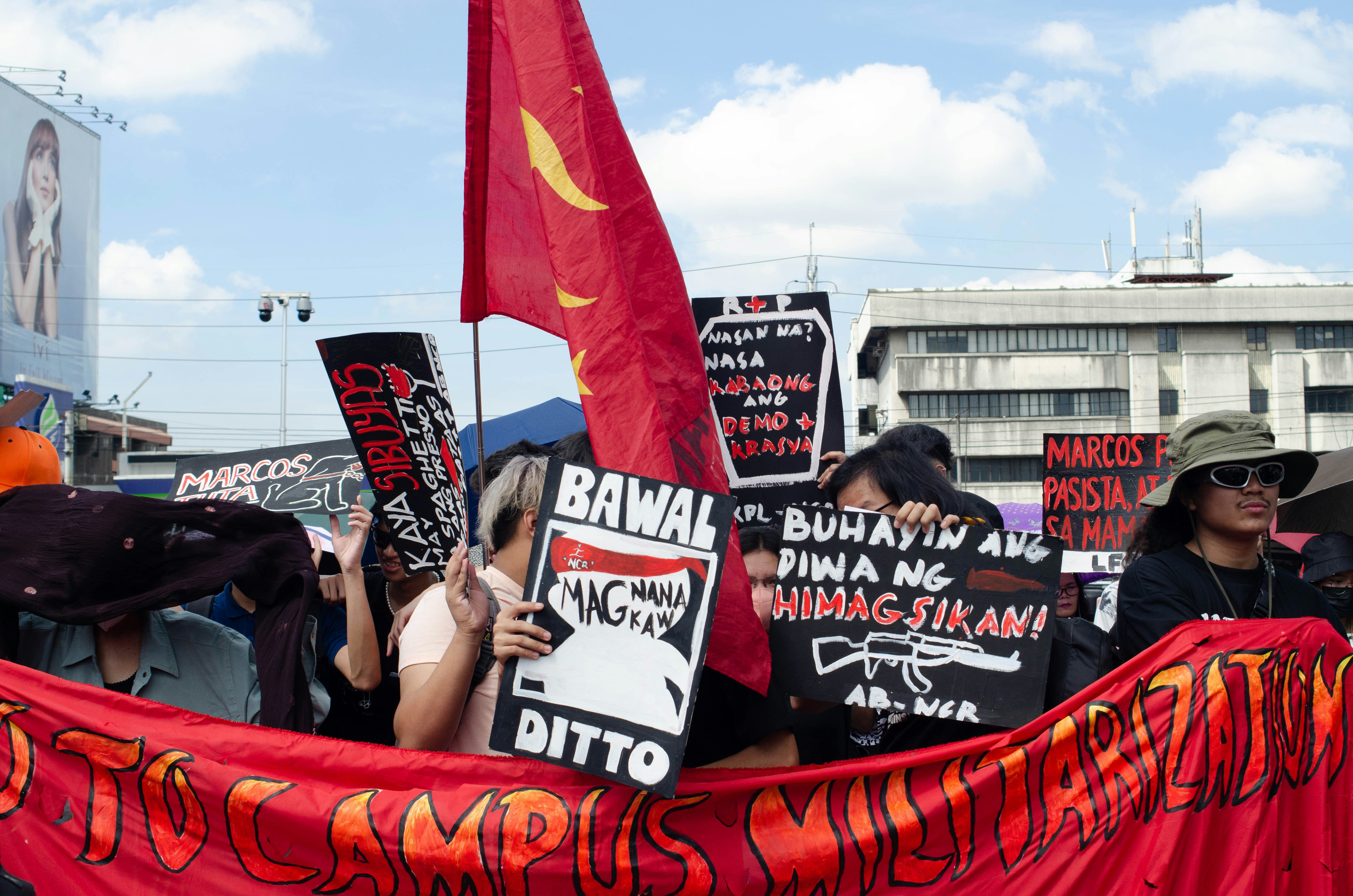 a group of people holding signs and flags