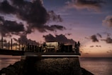 A group of travelers enjoying a sunset view on a cliff.