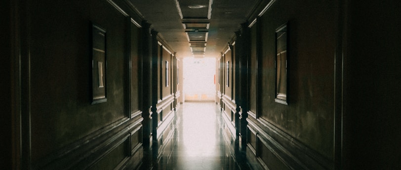 A tidy hallway with polished floors and freshly painted walls.