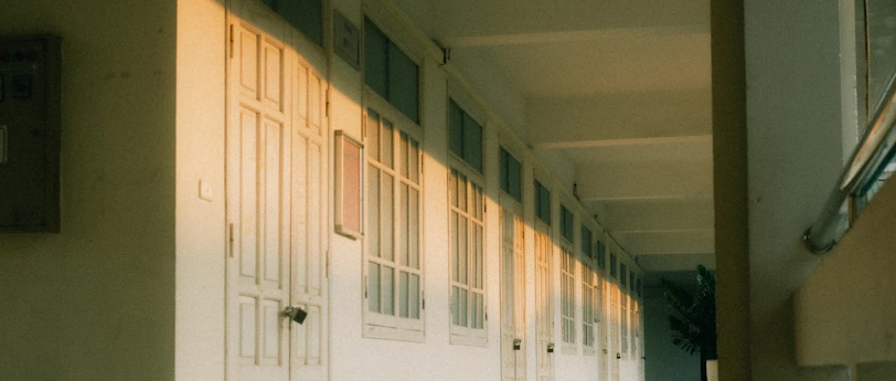 A hallway with soft, warm white paint reflecting sunlight, ready for quick tenant turnover.