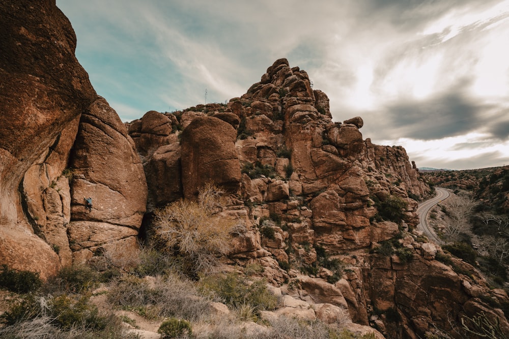 a person climbing up the side of a mountain