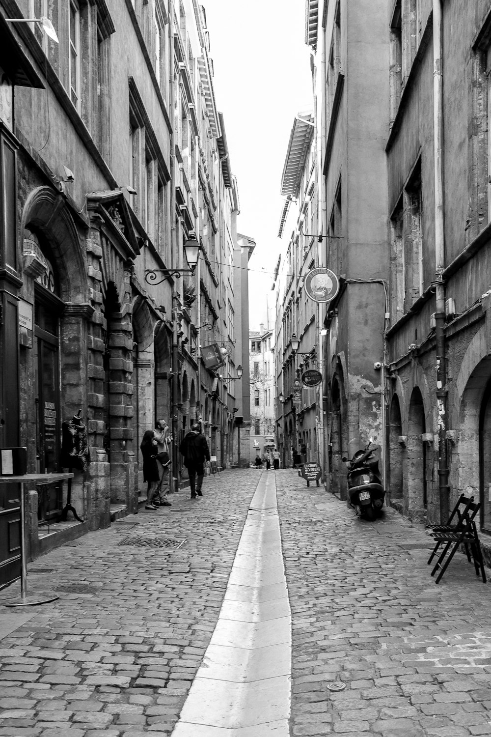 a black and white photo of a cobblestone street