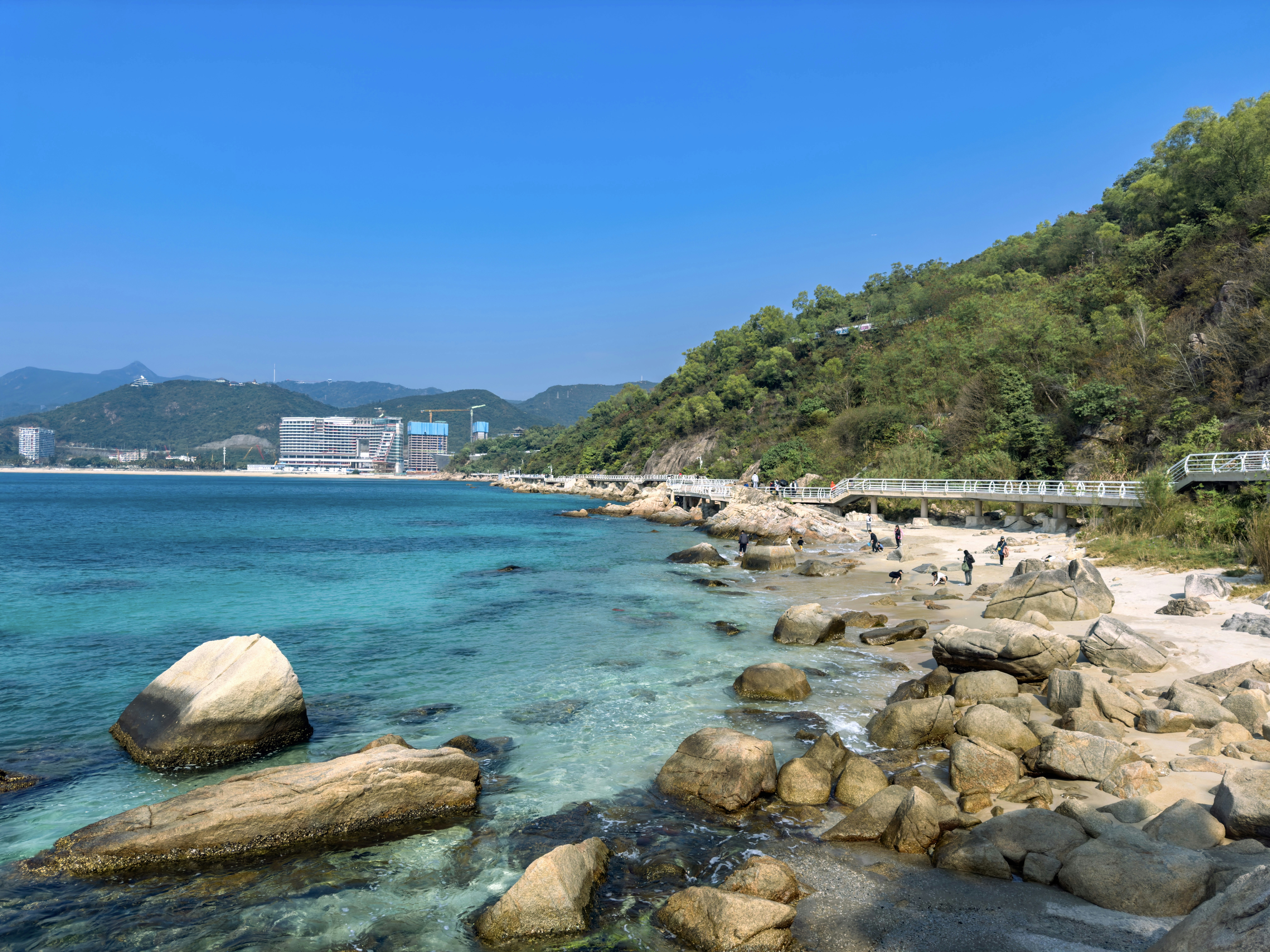 a view of a rocky beach with clear blue water