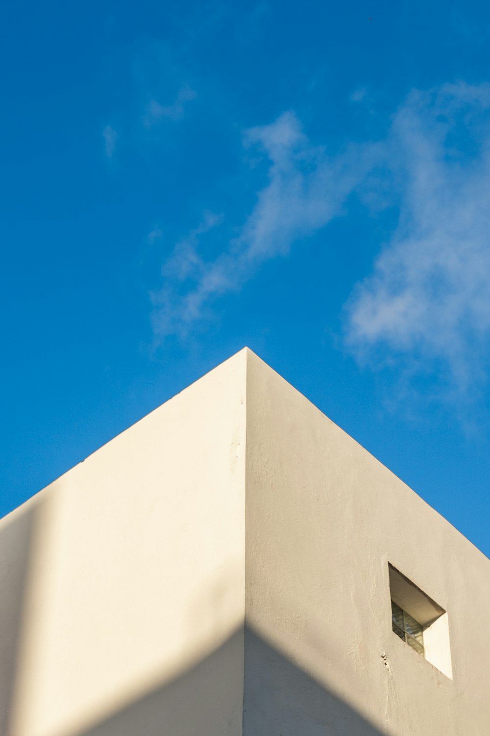 a white building with a blue sky in the background