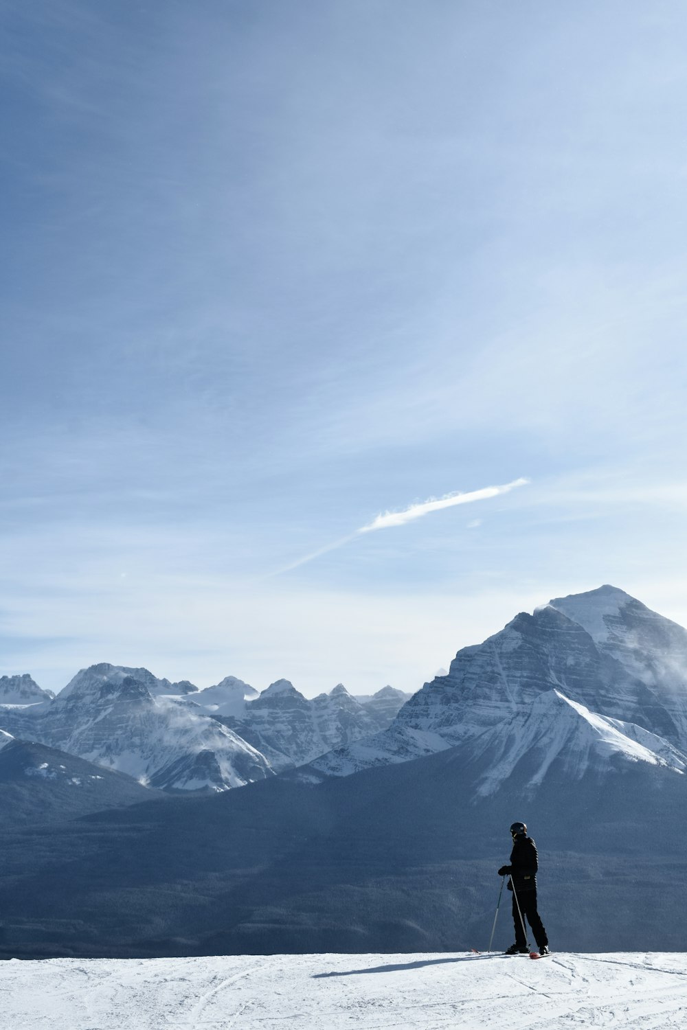 a person standing on top of a snow covered slope