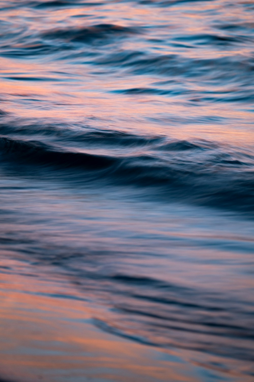 a blurry photo of the ocean at sunset