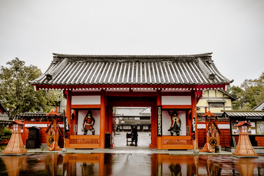 a person standing in front of a red and white building