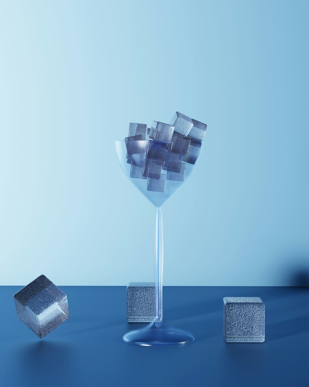 a glass of water with cubes on a table