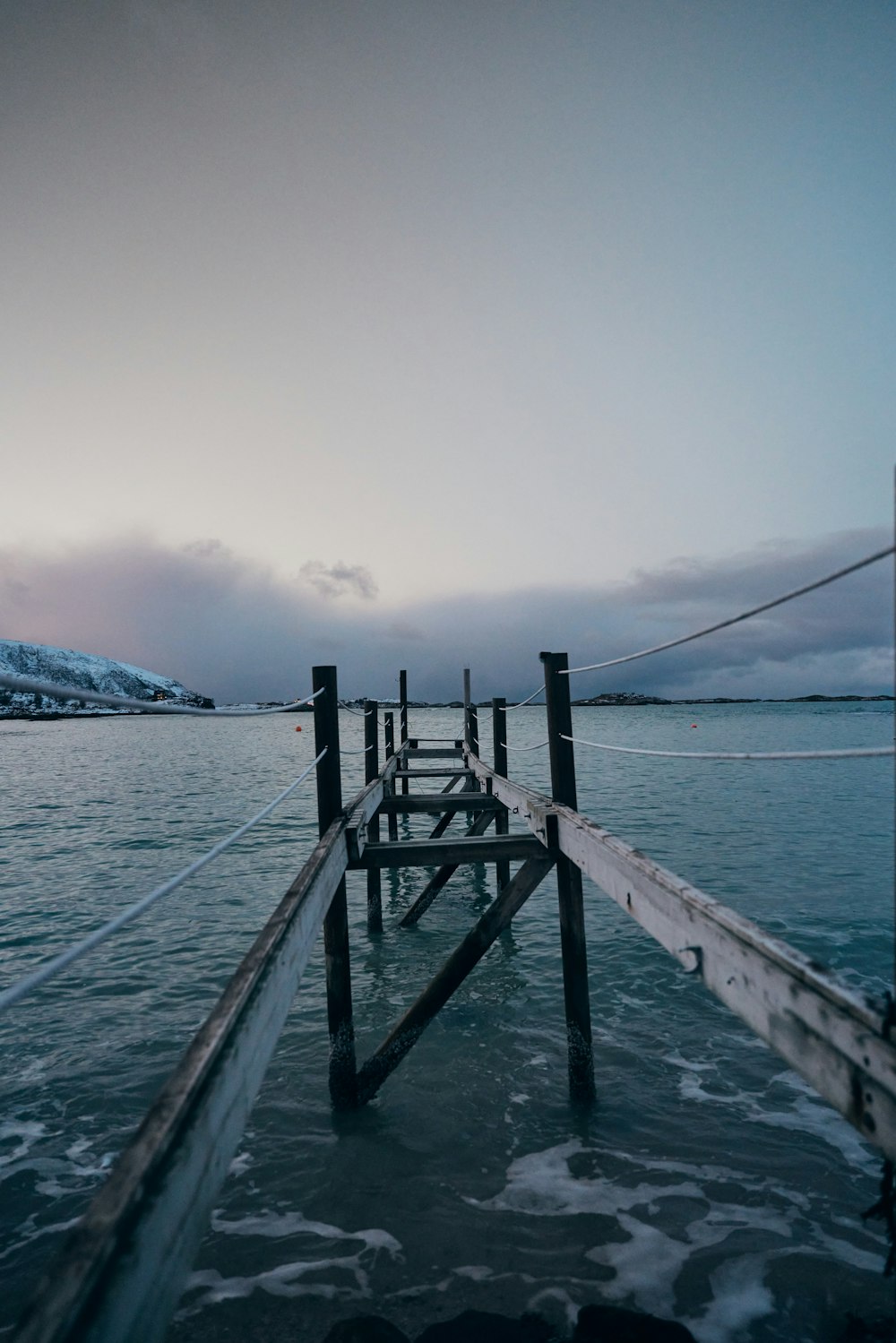 a wooden dock in the middle of a body of water