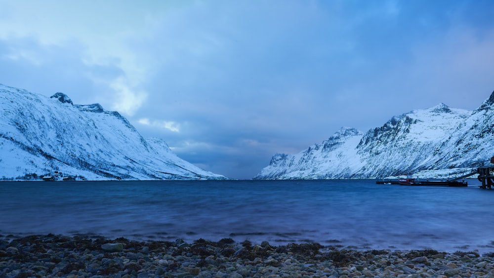 a mountain range with a body of water in the foreground