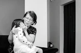 A mentor gently guiding a young girl through a heartfelt conversation in a cozy, colorful room