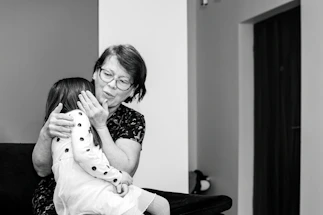 a woman holding a child in her arms