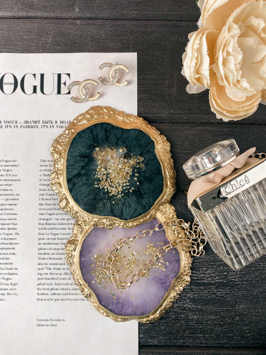 A stylish flat lay of trendy accessories including pastel-colored earrings and bracelets on a mint green surface