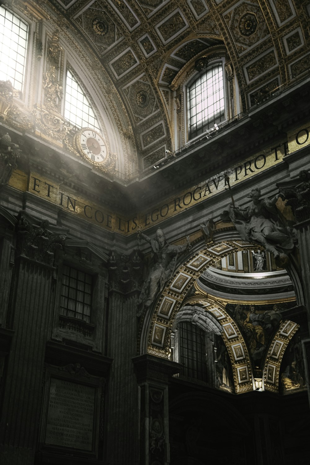 the ceiling of a building with a clock on it