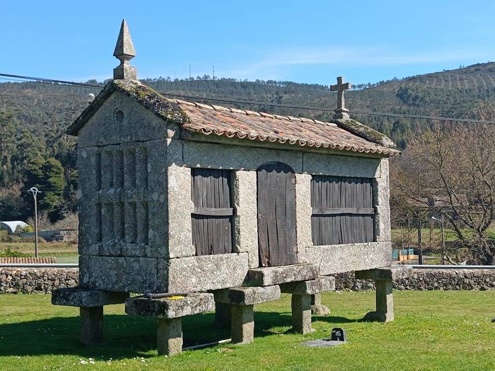 a stone structure with a roof and windows