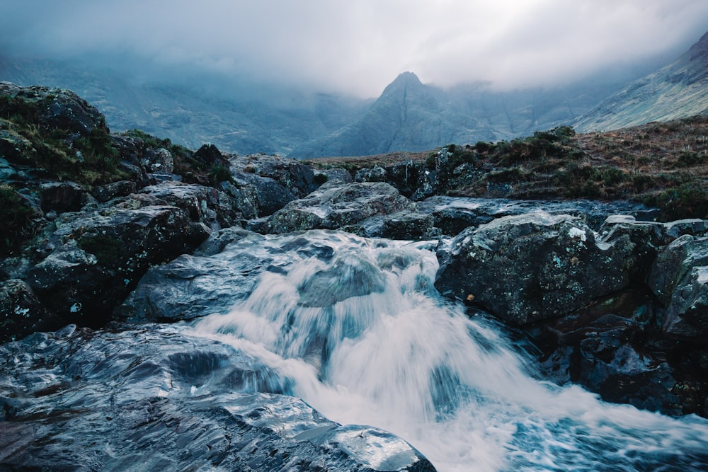 a mountain stream running through a rocky valley