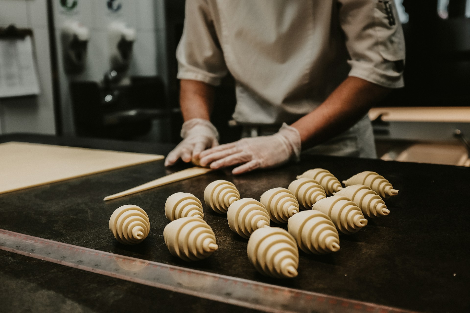 a person in a kitchen preparing food with chopsticks