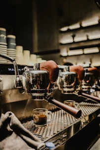 High-resolution photo of a heavy-duty Hambach espresso machine gleaming under soft lighting in a sleek cafe setting.