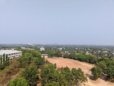 A vibrant aerial view of the emerald green football turf at Emerald Sports Hub under clear skies.