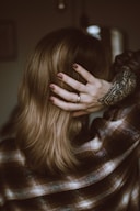 a woman with her hands on her head