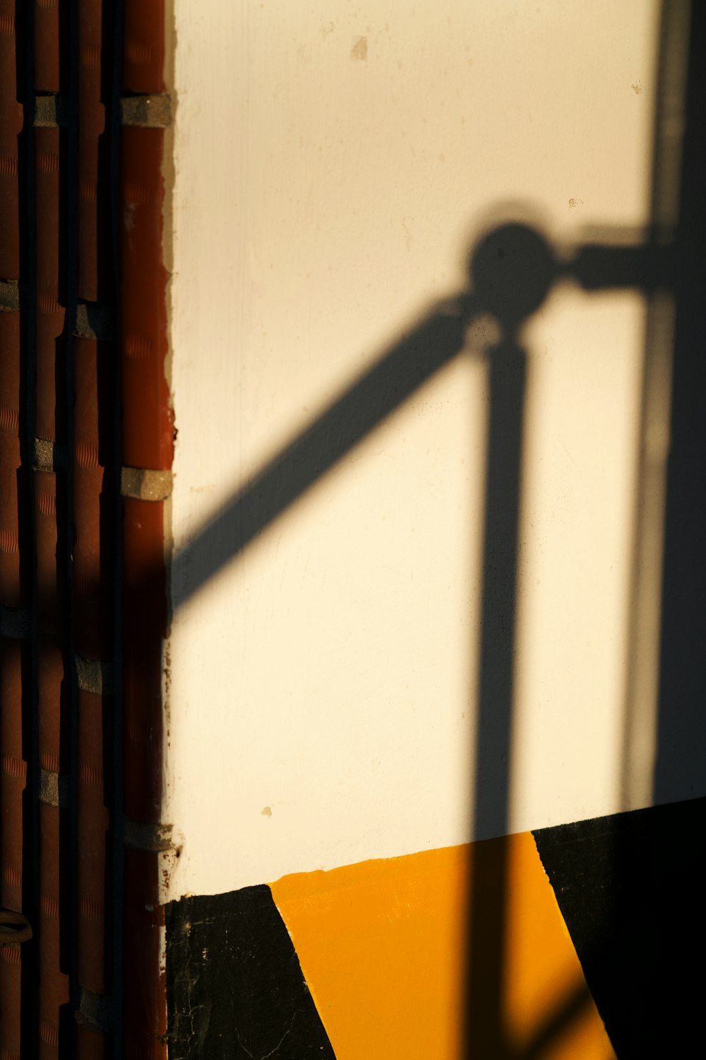 a shadow of a street light on a wall