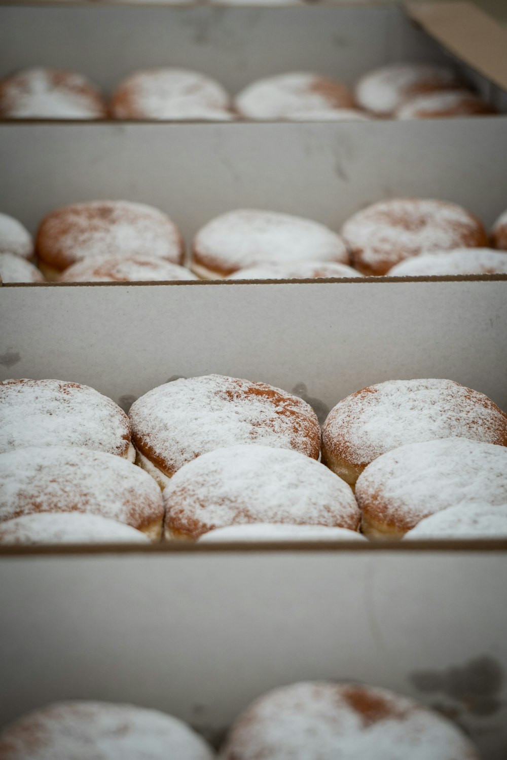 a couple of boxes filled with powdered donuts