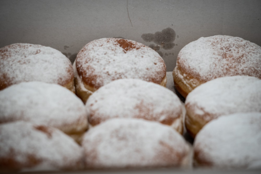 a box filled with lots of powdered donuts
