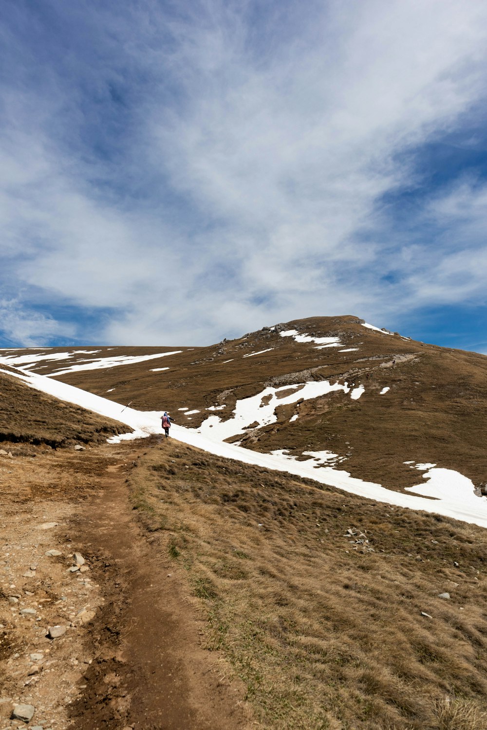 a person walking up a hill on a sunny day