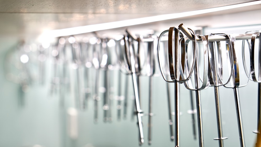 a row of surgical instruments hanging on a wall