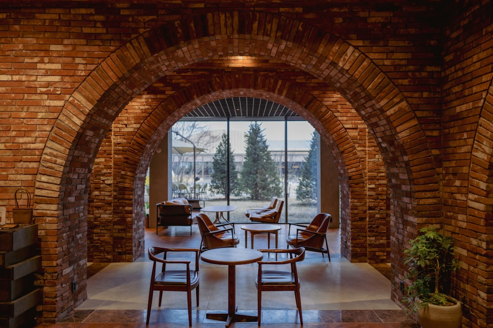 a room with a brick wall and arched doorway