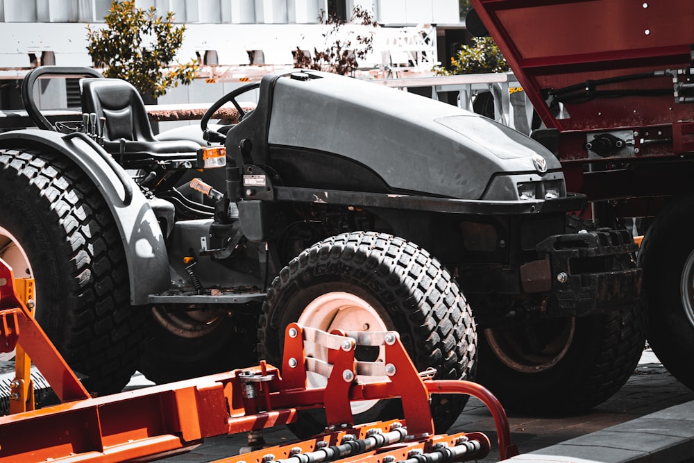 a red dump truck parked next to a red dump truck