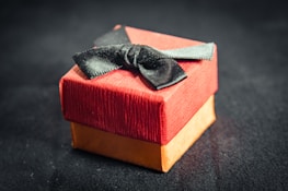 A warm ivory gift box tied with a muted gold ribbon, ready for gifting.