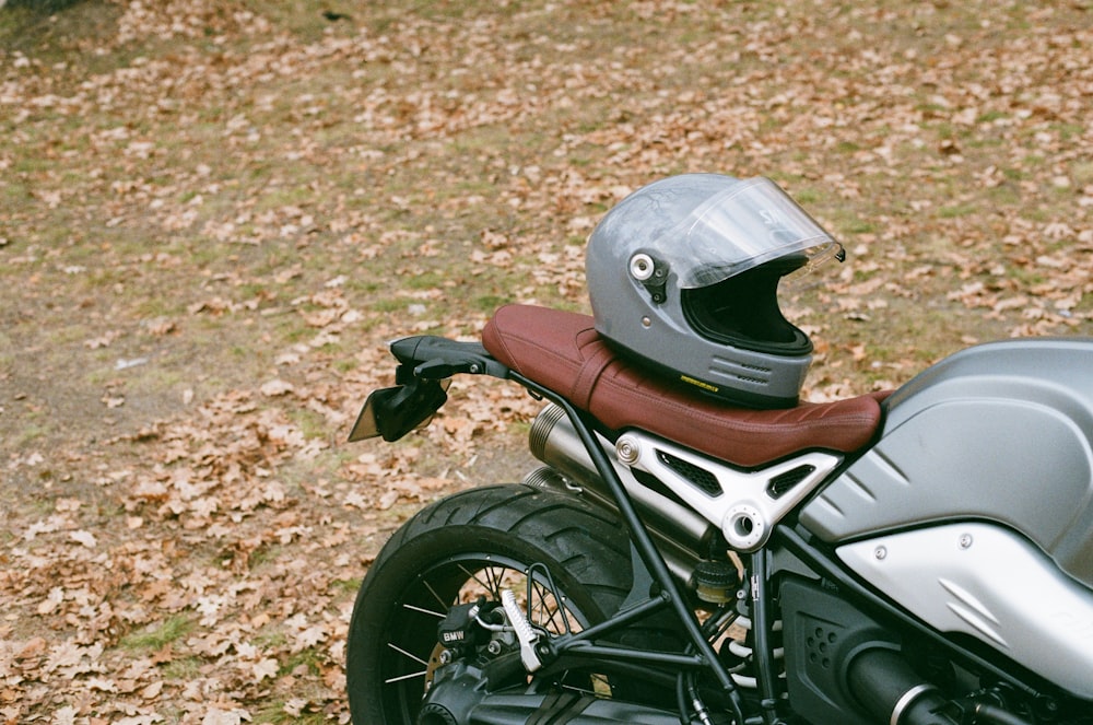 a motorcycle with a helmet is parked in the grass