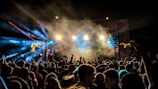 A crowd enjoying a live performance with sound equipment.