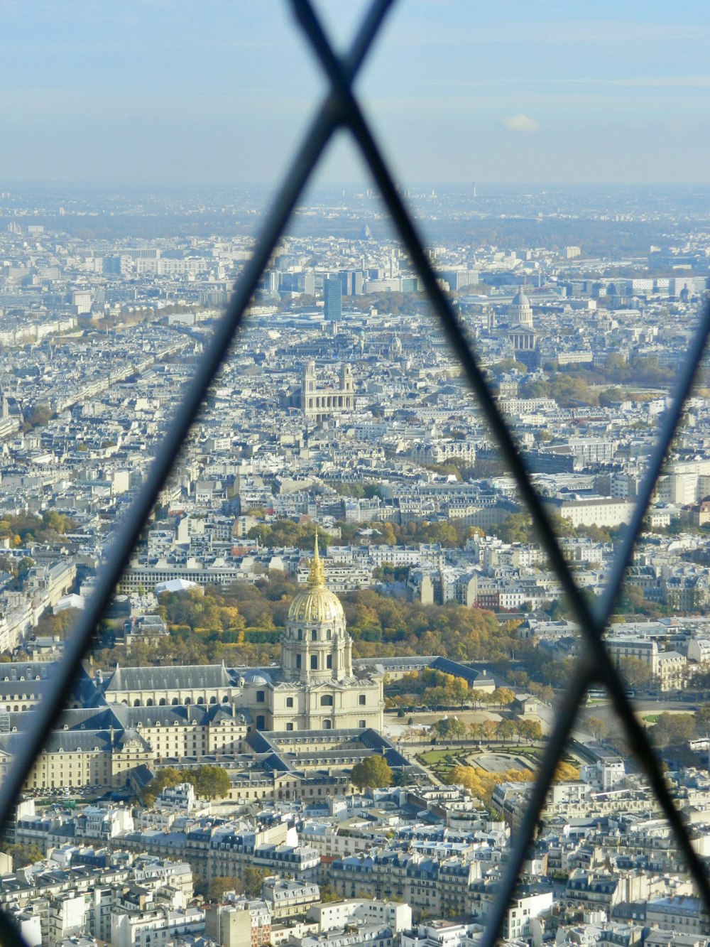 a view of a city through a fence