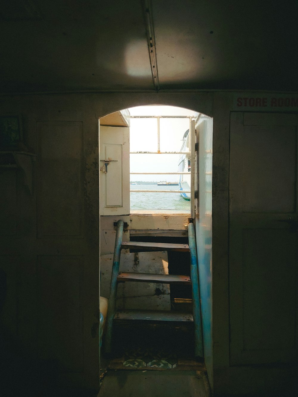 an open door leading to a boat in the water