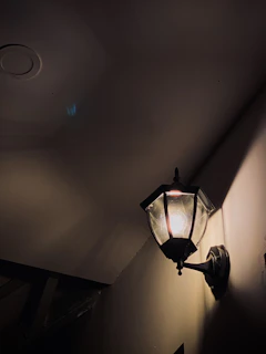 A rustic lantern-style lamp adding charm to a hallway corner.